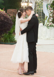 bride and groom forehead to forehead while outside
